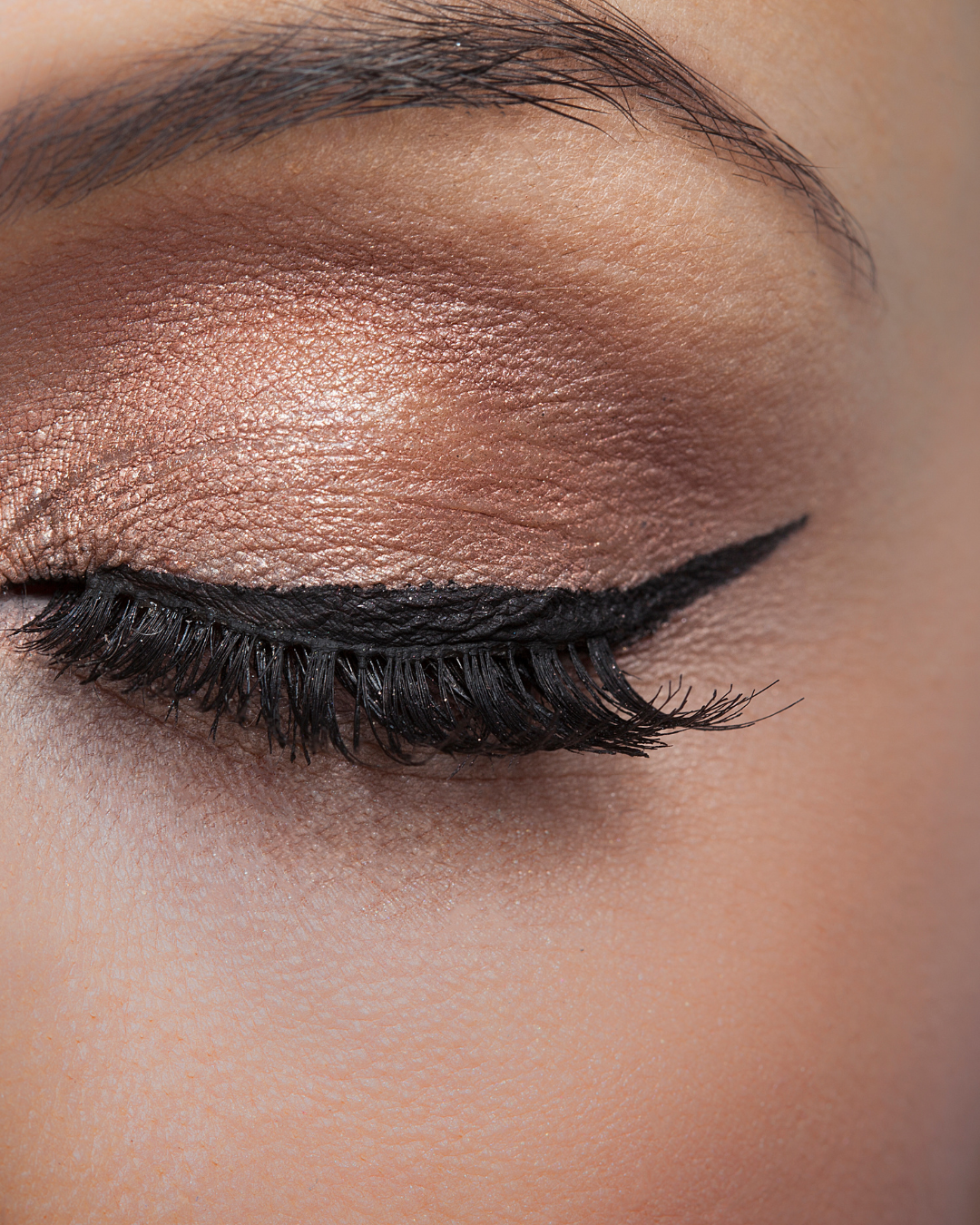 A close-up of eye makeup featuring the Champagne Glow eyeshadow shade. The soft, shimmering hue enhances the eyelid with a radiant, luminous finish, creating an elegant and natural look.