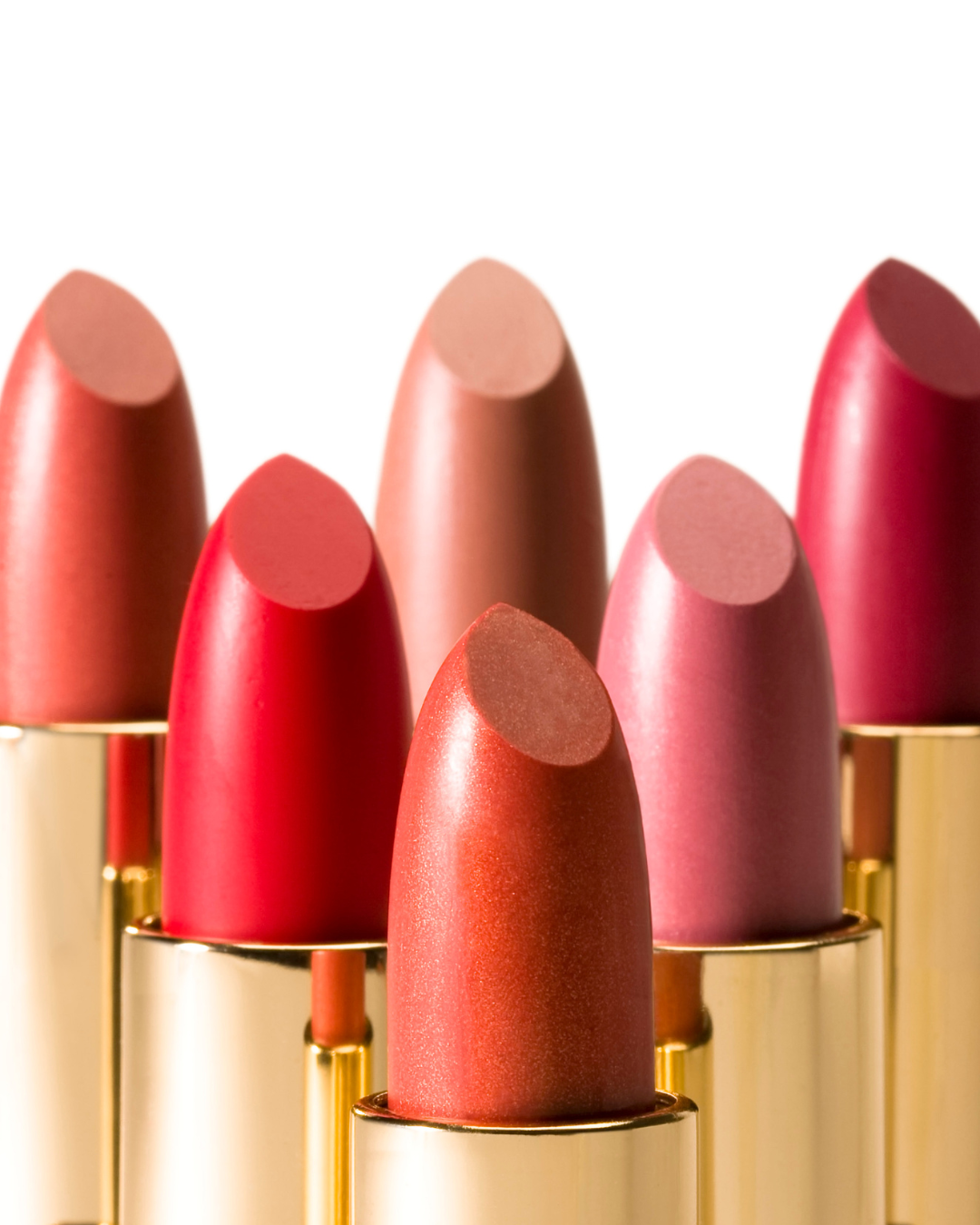 A collection of lipstick shades in refillable golden tubes, showcasing a range of vibrant, natural colors. Each shade delivers a smooth, moisturizing finish while the eco-friendly packaging emphasizes sustainability and conscious beauty.